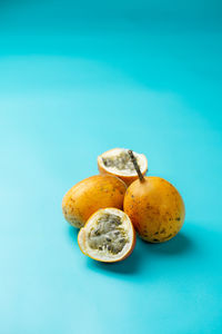 Passion fruit photographed on a light blue background.