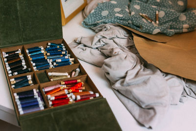 High angle view of thread spools in box at home