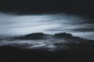 Scenic view of landscape against sky at night