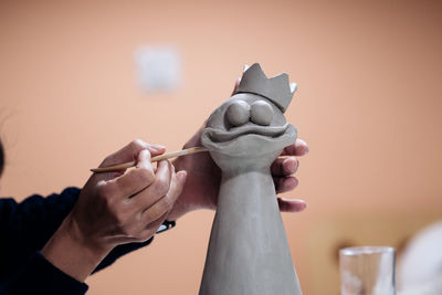 Cropped image of artist sculpting bird at workshop