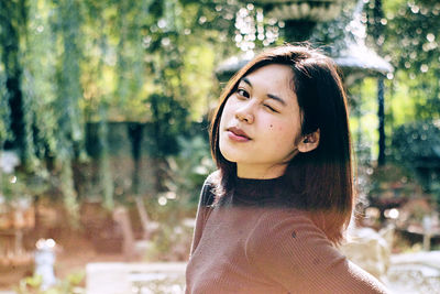 Portrait of beautiful young woman looking away