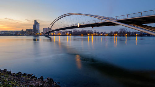 Bridge over river at dusk