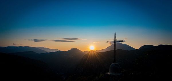 Scenic view of silhouette mountains against sky during sunset