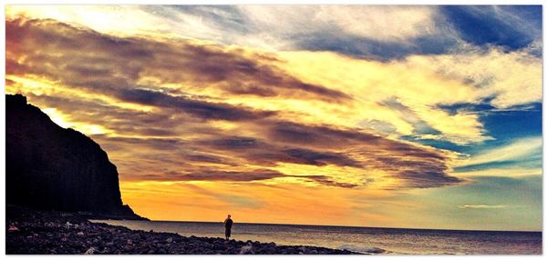 Scenic view of sea against cloudy sky