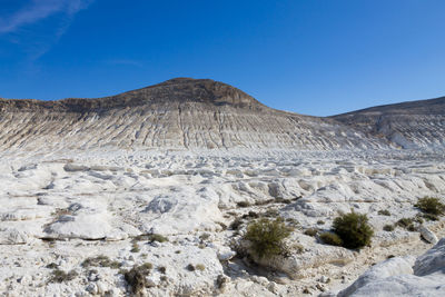 Scenic view of mountains against clear blue sky