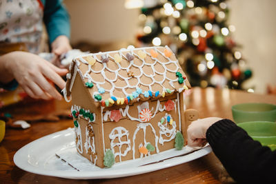 Gingerbread house being decorated at home