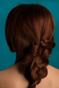 Rear view of woman with hairstyle over blue background