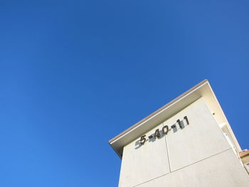 Low angle view of building against clear blue sky