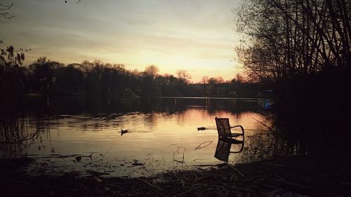 Scenic view of lake at sunset