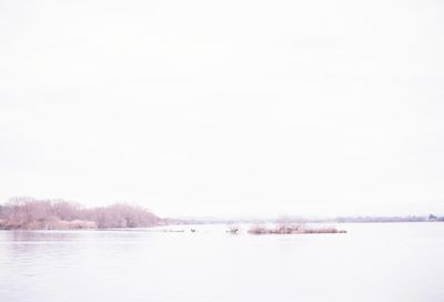 Scenic view of calm lake against clear sky