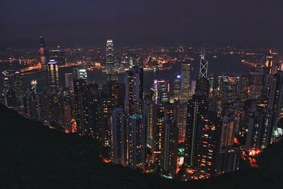 High angle view of illuminated cityscape against sky at night