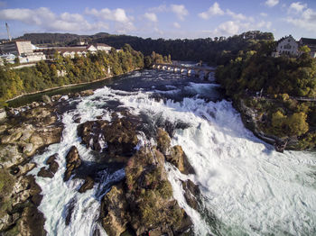 Scenic view of waterfall against sky