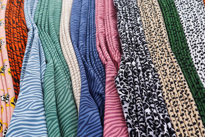 Detailed close up view on samples of cloth and fabrics in different colors found at a fabrics market