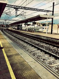 Train at railroad station against sky