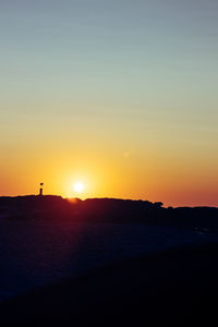 Scenic view of beach against sky during sunset