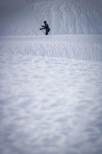 Side view of mature man skiing on snowcapped mountain