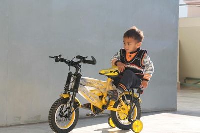 Full length of a boy riding bicycle
