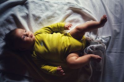 Directly above shot of baby boy lying on bed