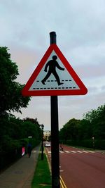 Road sign against sky