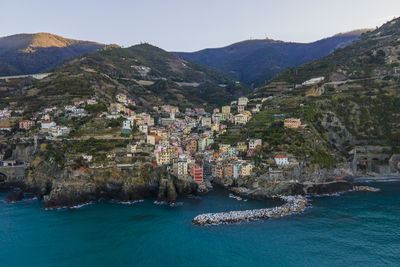 High angle view of townscape by sea against sky