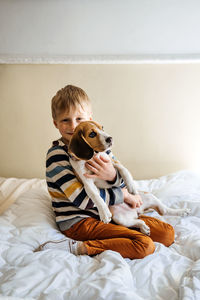 Full length of baby boy on bed at home