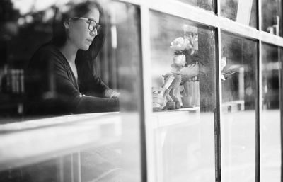 Woman seen through window