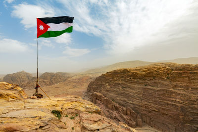 Low angle view of flag against mountain