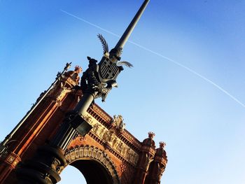 Low angle view of built structure against clear blue sky