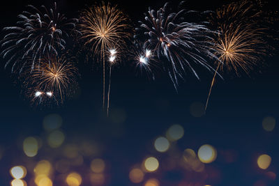 Low angle view of firework display at night