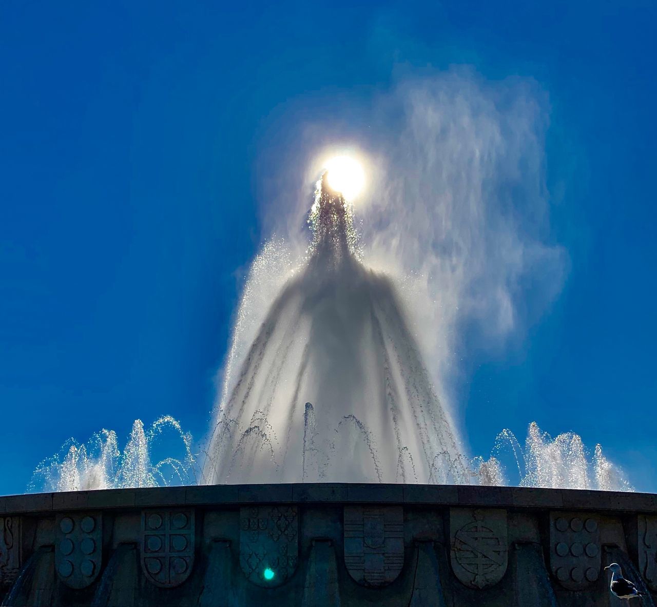 LOW ANGLE VIEW OF FOUNTAIN AGAINST CLOUDY SKY