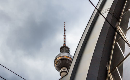 Low angle view of fernsehturm against sky at dusk in city
