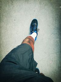 Low section of person standing on road