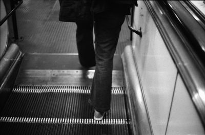 Low section of man on escalator