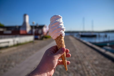 Close-up of hand holding ice cream