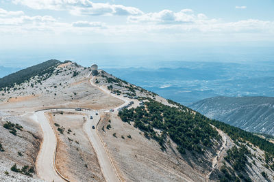 High angle view of road by mountains against sky