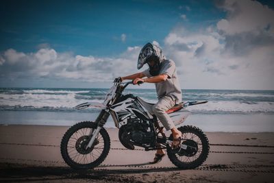 Man riding bicycle on beach