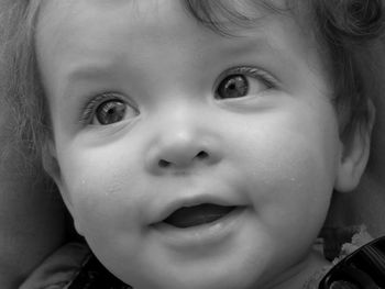 Close-up of cute smiling baby girl looking away