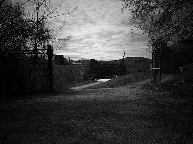 architecture, built structure, sky, building exterior, bare tree, tree, the way forward, house, cloud - sky, cloud, landscape, empty, no people, road, outdoors, day, residential structure, field, cloudy, transportation