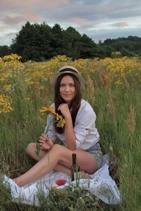 Young woman sitting on field
