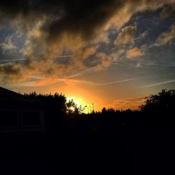 Silhouette of trees against dramatic sky