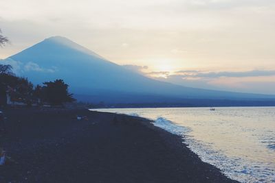 Scenic view of mountains against sky at sunset