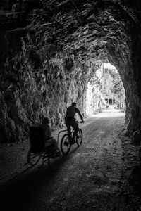 Man riding pedicab in tunnel