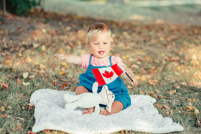 Cute girl sitting on field