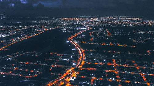 High angle view of illuminated cityscape at night