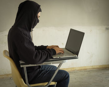 Side view of man using mobile phone