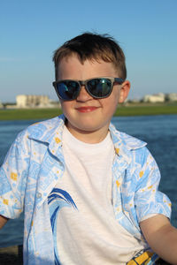 Portrait of boy wearing sunglasses against sky