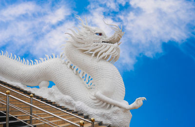 Low angle view of statue against blue sky