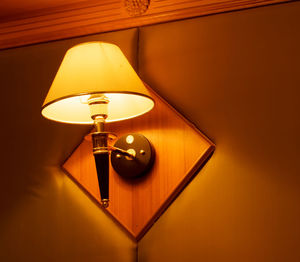 Low angle view of illuminated electric lamp