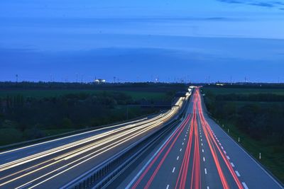 High angle view of light trails on highway at night