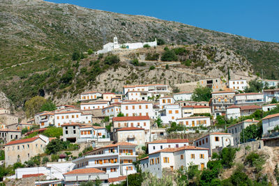 Buildings in town against sky